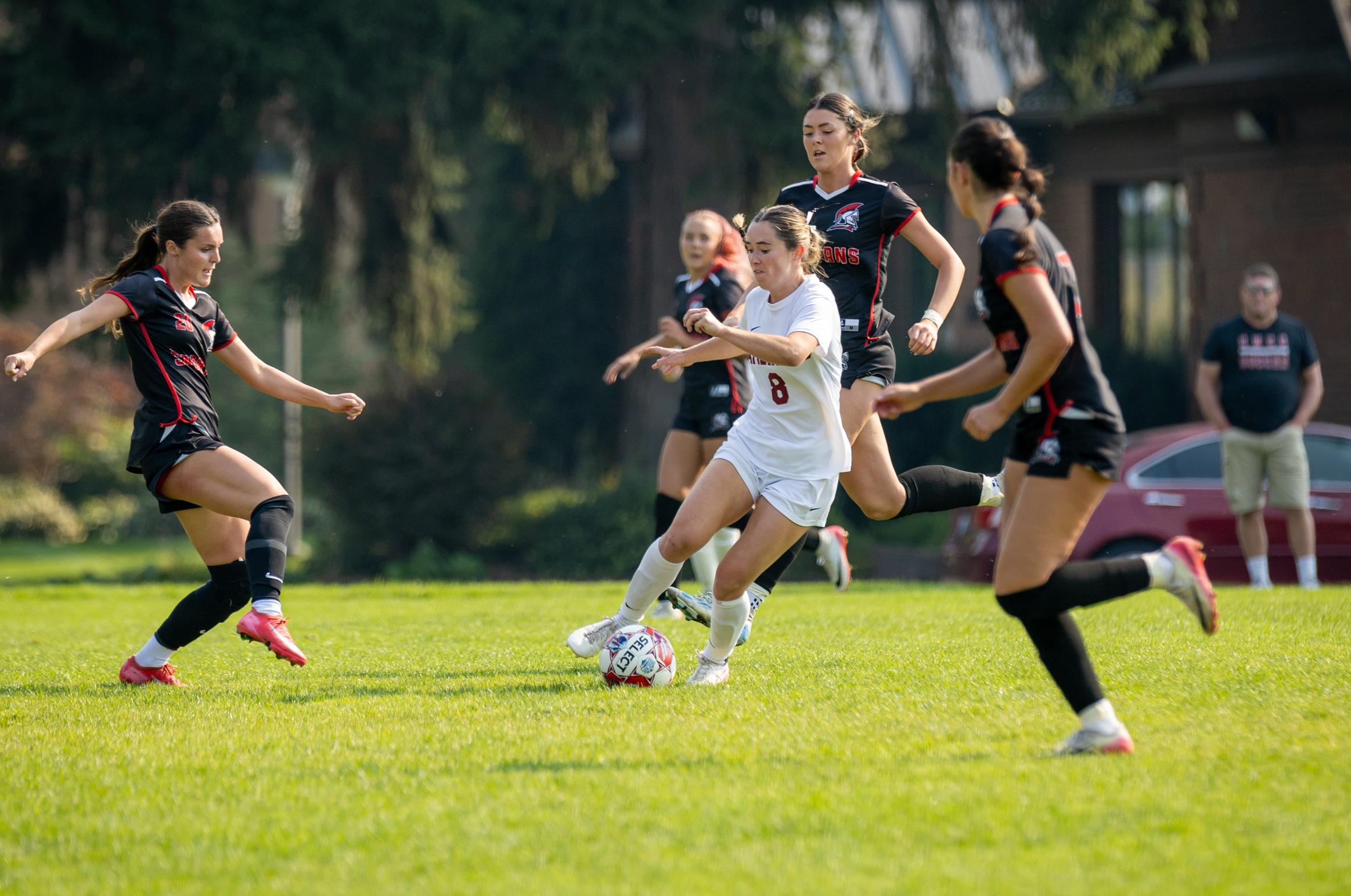 Molly McClennan dribbles through CNCC players