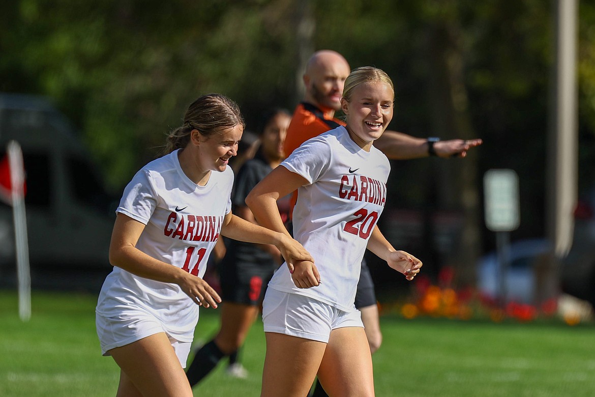 KYLE DISHAW PHOTOGRAPHY North Idaho College freshman midfielder Hannah Rommes (20) celebrates with teammate Madeline Cook (11) after scoring a first-half goal in Saturday's Scenic West Athletic Conference match against Pacific Northwest Christian at Eisenwinter Field.